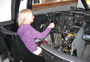Johanna in the cockpit of an unknown airplane at the air museum